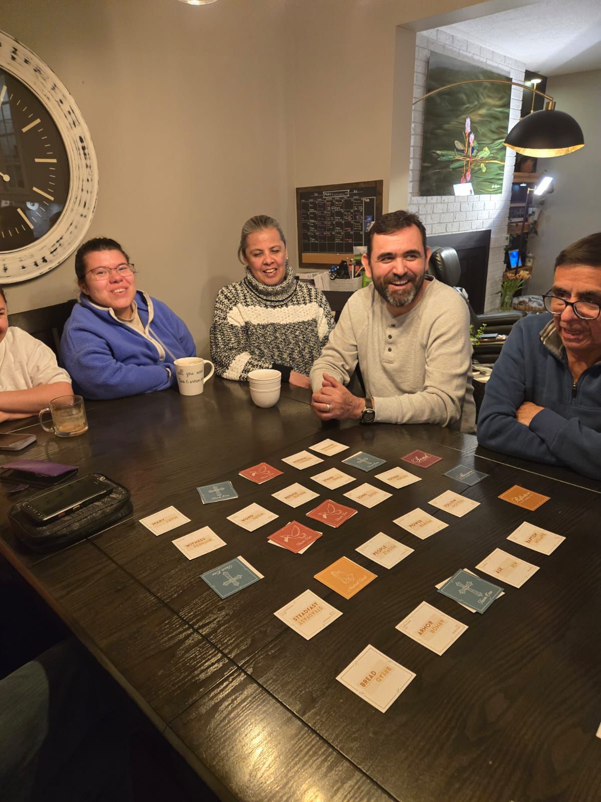 Family gathered around a dining table playing Revival
